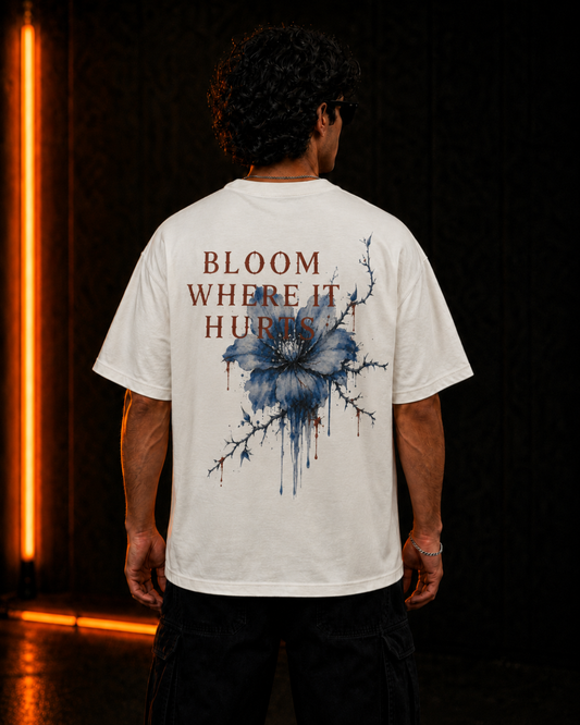 Bloom Where It Hurts oversized off-white tee, back print on model