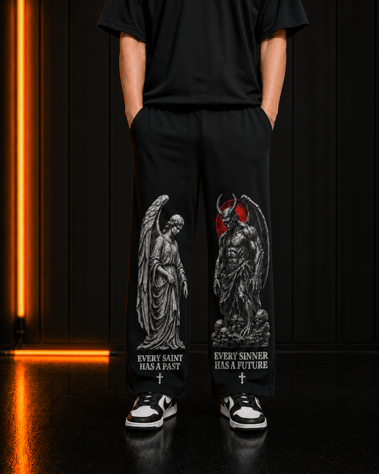 Saint & Sinner black trackpants, both leg prints on model