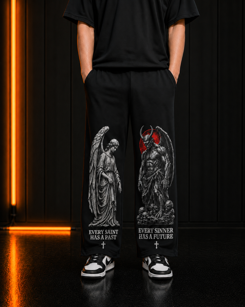 Saint & Sinner black trackpants, both leg prints on model